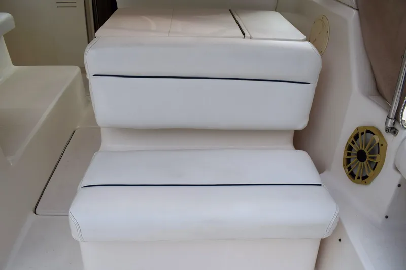 Slide: The Image of White cushioned seating on 2002 Tiara Yachts 2900 Coronet boat interior. - 6