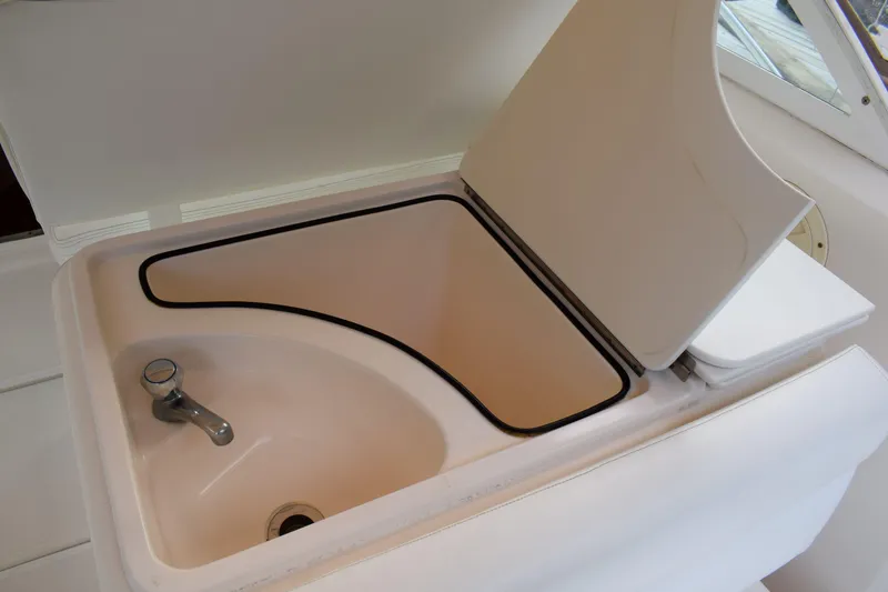 Slide: The Image of 2002 Tiara 2900 Coronet boat sink with open lid and faucet. - 9