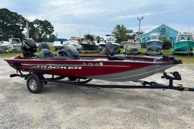 The Image of 2023 Tracker Pro Team 175 TXW boat on trailer, parked in a marina. - 0