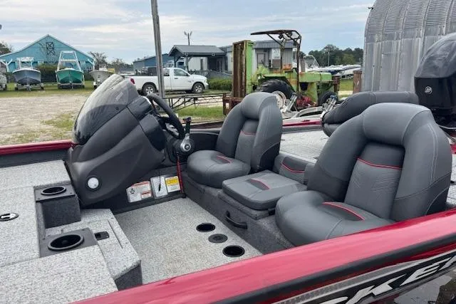 Slide: The Image of 2023 Tracker Pro Team 175 TXW boat interior with gray seating and steering console. - 10