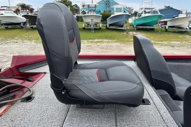 Slide: The Image of 2023 Tracker Pro Team 175 TXW boat seats, gray upholstery, outdoor setting with boats in background. - 13