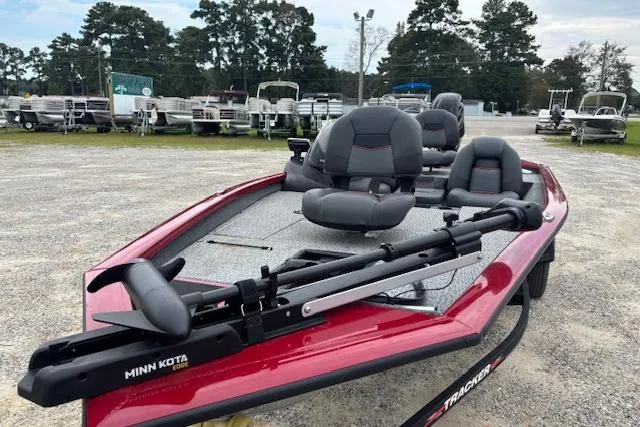 Slide: The Image of 2023 Tracker Pro Team 175 TXW boat with Minn Kota trolling motor, parked outdoors. - 7