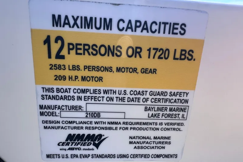 Slide: The Image of 2018 Bayliner 210 Deck Boat capacity label, 12 persons or 1720 lbs, 209 HP motor. - 13