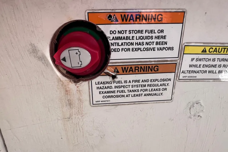 Slide: The Image of Battery switch and warning labels on a 2018 Bayliner 210 Deck Boat. - 19