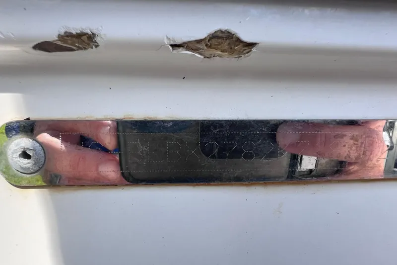 Slide: The Image of Close-up of a 2018 Bayliner 210 Deck Boat hull identification number plate. - 24