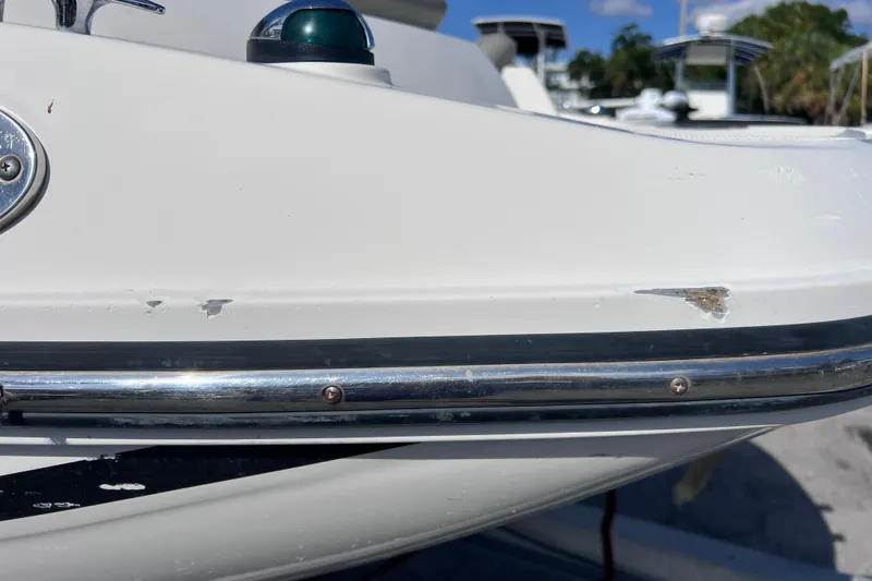 Slide: The Image of 2018 Bayliner 210 Deck Boat with minor hull damage and chrome detailing. - 27
