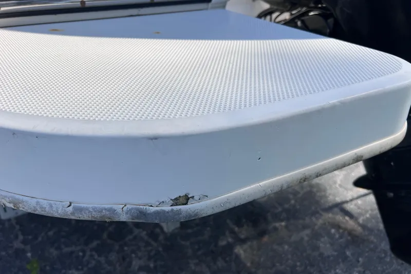 Slide: The Image of 2018 Bayliner 210 Deck Boat with minor hull damage visible. - 28