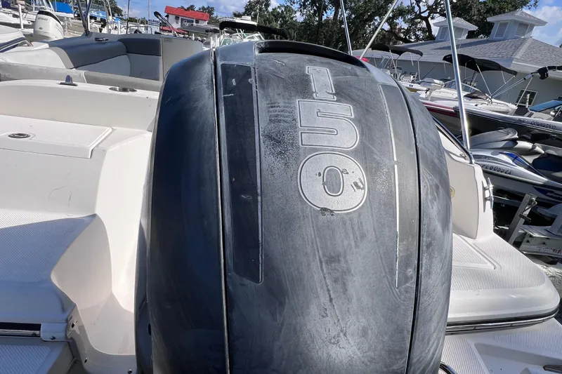 Slide: The Image of 2018 Bayliner 210 Deck Boat with 150 HP engine, docked in marina. - 4