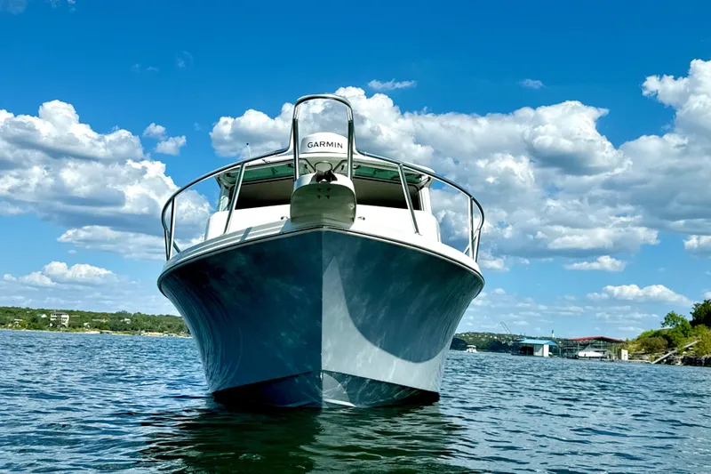 Slide: The Image of 2023 Parker 2820 XLD Sport Cabin boat on a sunny lake with blue skies. - 10