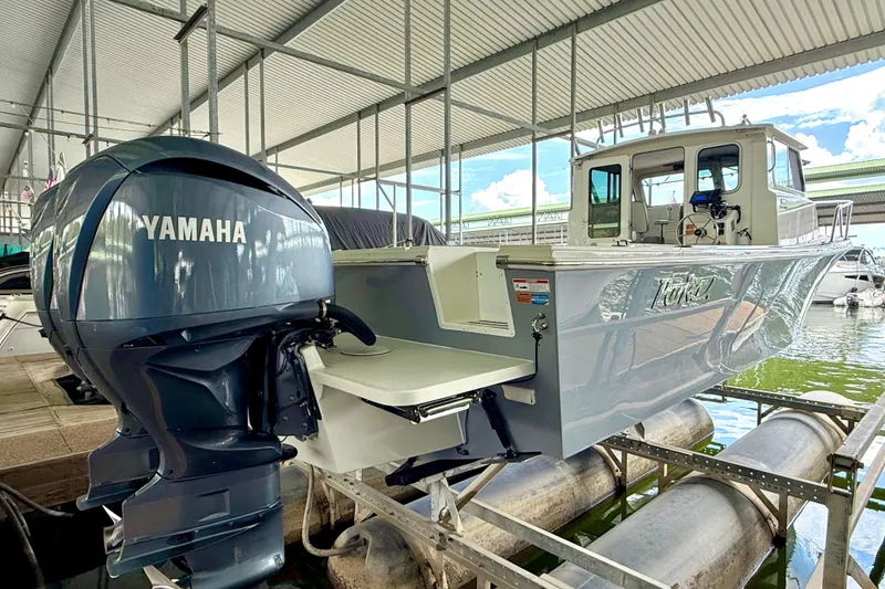Slide: The Image of 2023 Parker 2820 XLD Sport Cabin boat with Yamaha engine in marina setting. - 12