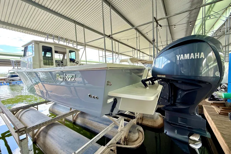 Slide: The Image of 2023 Parker 2820 XLD Sport Cabin boat with Yamaha engine in covered dock. - 14