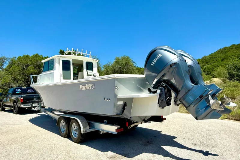 Slide: The Image of 2023 Parker 2820 XLD Sport Cabin boat on trailer with Yamaha outboard engines. - 18