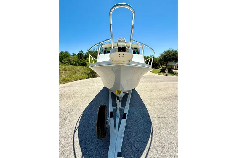 Slide: The Image of 2023 Parker 2820 XLD Sport Cabin boat on trailer under clear blue sky. - 23