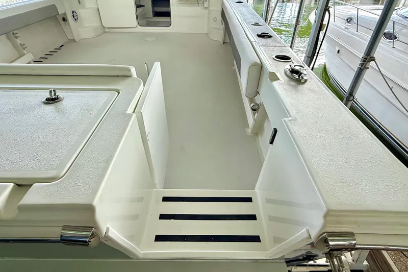 Slide: The Image of 2023 Parker 2820 XLD Sport Cabin boat interior, featuring spacious deck and storage compartments. - 25