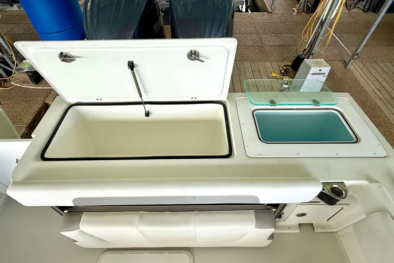 Slide: The Image of 2023 Parker 2820 XLD Sport Cabin boat interior with open storage compartments. - 27