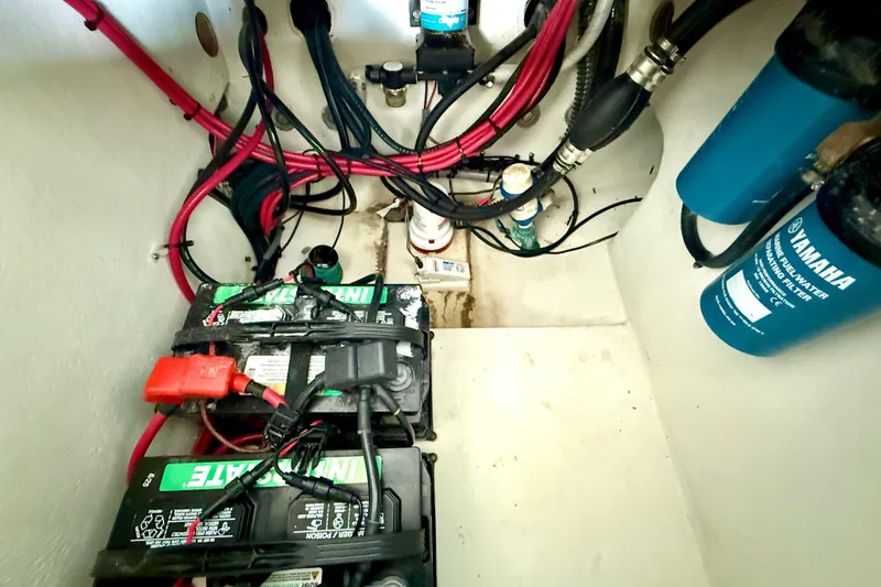 Slide: The Image of 2023 Parker 2820 XLD Sport Cabin engine compartment with batteries and wiring. - 30