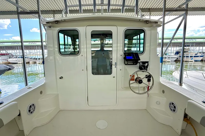 Slide: The Image of 2023 Parker 2820 XLD Sport Cabin boat interior with steering wheel and control panel. - 35