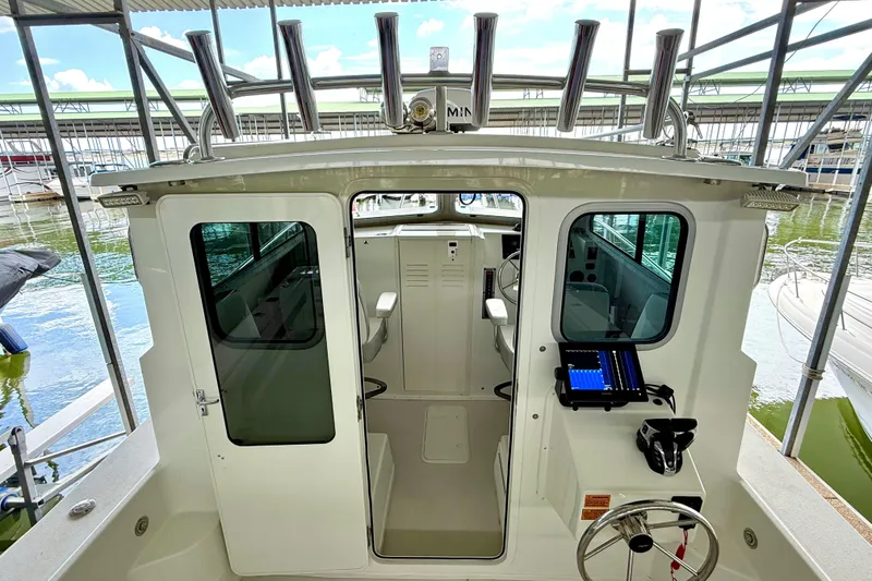 Slide: The Image of 2023 Parker 2820 XLD Sport Cabin boat interior with helm and seating area. - 36