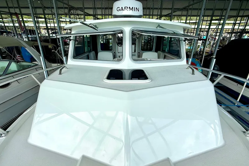 Slide: The Image of 2023 Parker 2820 XLD Sport Cabin boat with Garmin equipment in a marina. - 37