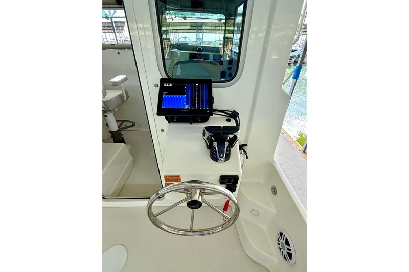 Slide: The Image of 2023 Parker 2820 XLD Sport Cabin helm with steering wheel and navigation display. - 40