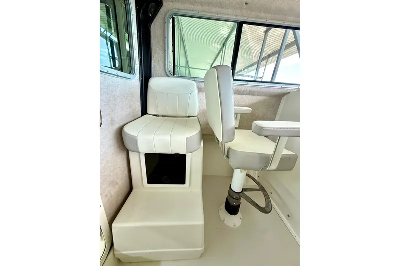 Slide: The Image of Interior of 2023 Parker 2820 XLD Sport Cabin, featuring white seating and windows. - 42