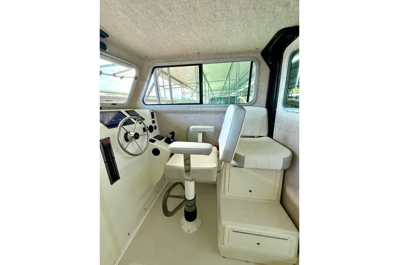 Slide: The Image of Interior of 2023 Parker 2820 XLD Sport Cabin, featuring helm and seating area. - 43