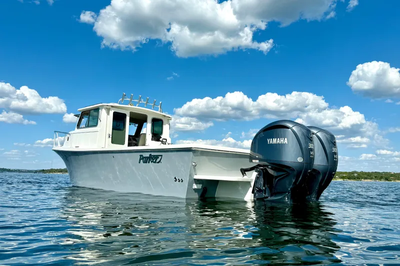 Slide: The Image of 2023 Parker 2820 XLD Sport Cabin boat with Yamaha engines on a sunny day. - 5