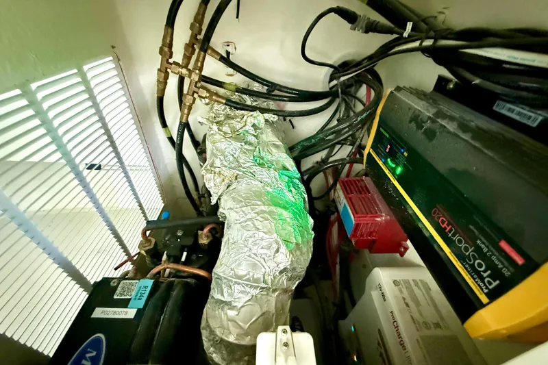 Slide: The Image of Electrical and mechanical components inside a 2023 Parker 2820 XLD Sport Cabin boat. - 61