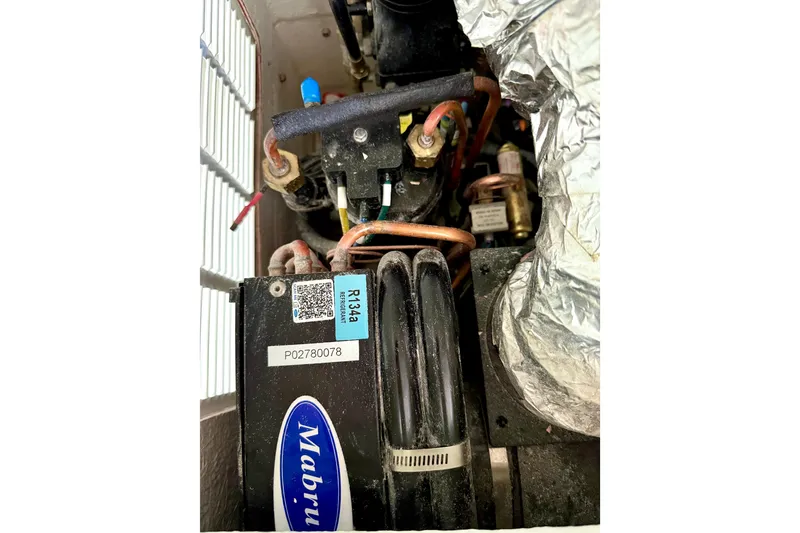 Slide: The Image of Close-up of Parker 2820 XLD Sport Cabin 2023 engine components with R134a refrigerant label. - 62