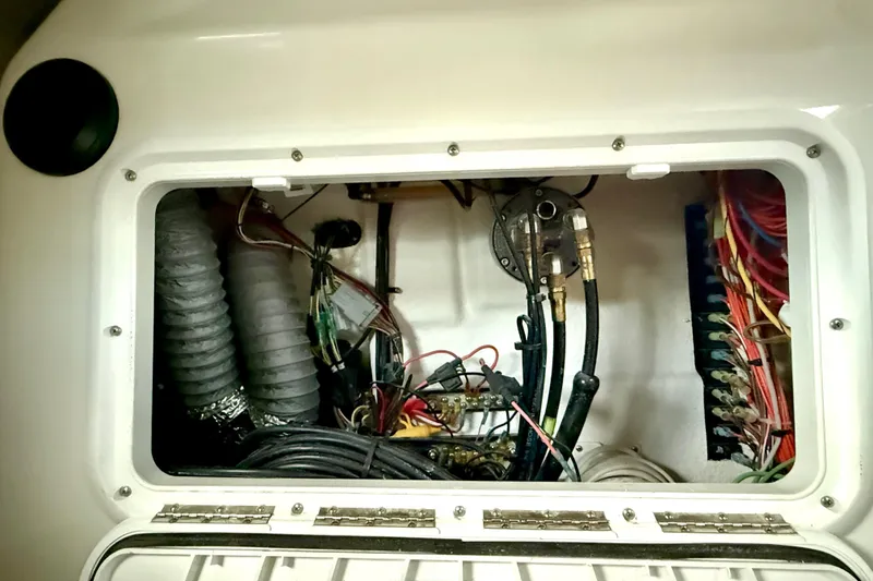 Slide: The Image of 2023 Parker 2820 XLD Sport Cabin engine compartment with wiring and hoses. - 67