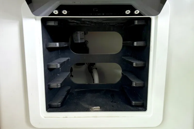 Slide: The Image of Storage compartment inside 2023 Parker 2820 XLD Sport Cabin boat, featuring shelves and visible wiring. - 69