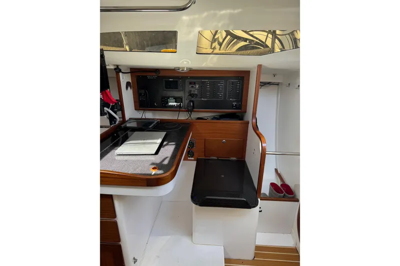 Slide: The Image of 2019 J Boats J/121 interior navigation station with control panel and seating. - 13
