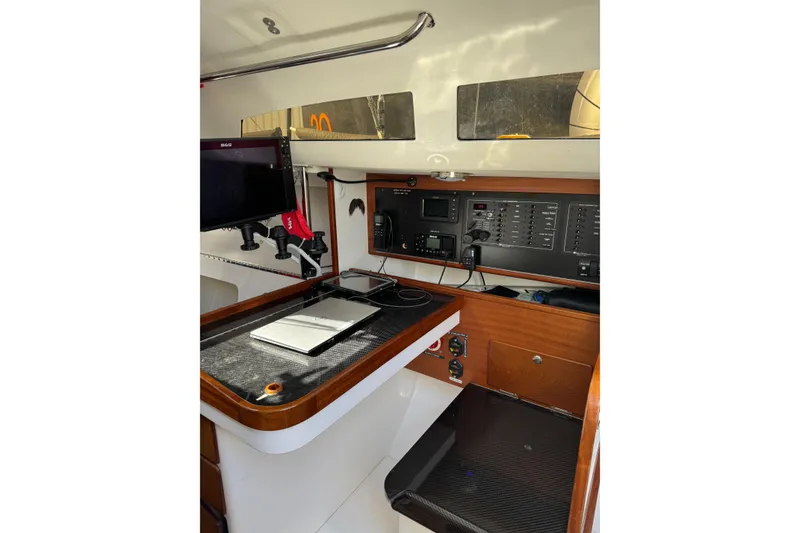 Slide: The Image of 2019 J Boats J/121 interior navigation station with control panel and equipment. - 14