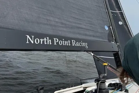 Slide: The Image of 2019 J Boats J/121 sailboat with "North Point Racing" on the sail, sailing on open water. - 2