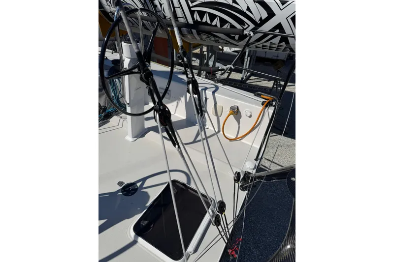 Slide: The Image of 2019 J Boats J/121 sailboat cockpit with steering wheel and rigging details. - 27