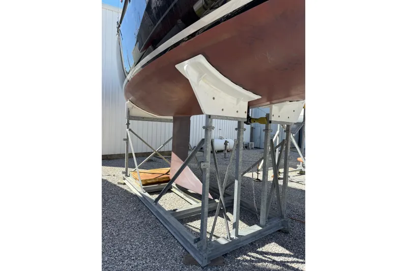 Slide: The Image of 2019 J Boats J/121 sailboat hull on metal stands in a boatyard. - 34