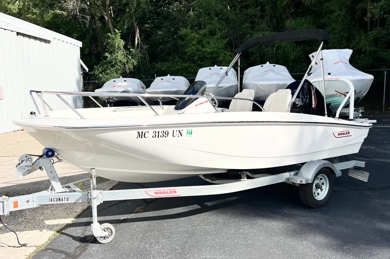 Slide: The Image of 2021 Boston Whaler 160 Super Sport boat on trailer, parked outdoors. - 0