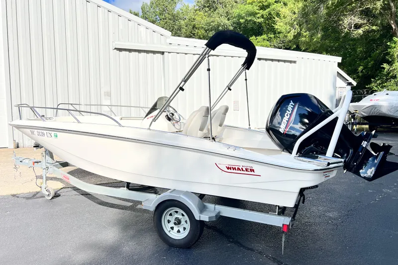 Slide: The Image of 2021 Boston Whaler 160 Super Sport boat on trailer, parked outdoors. - 1