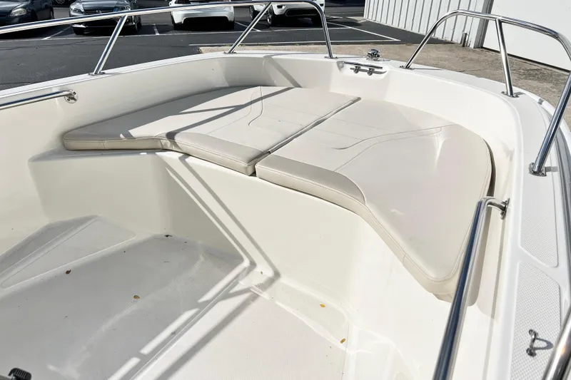 Slide: The Image of 2021 Boston Whaler 160 Super Sport boat interior with cushioned seating. - 10