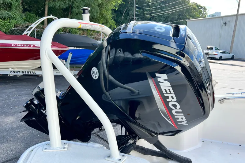 Slide: The Image of 2021 Boston Whaler 160 Super Sport with Mercury outboard motor in a parking lot. - 6