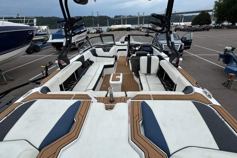 Slide: The Image of 2020 Nautique Super Air Nautique GS22 interior with white seating and wood accents. - 14