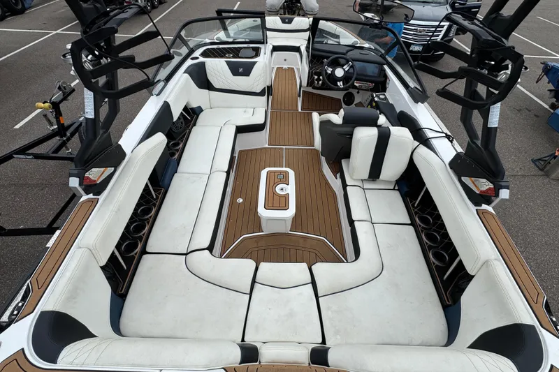 Slide: The Image of 2020 Nautique Super Air Nautique GS22 interior with luxury seating and steering wheel. - 15
