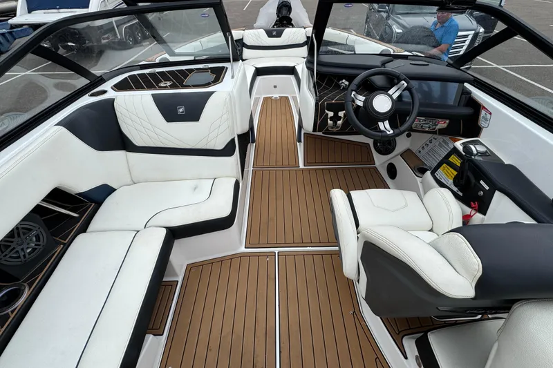 Slide: The Image of 2020 Nautique Super Air Nautique GS22 interior with white seating and modern dashboard. - 16