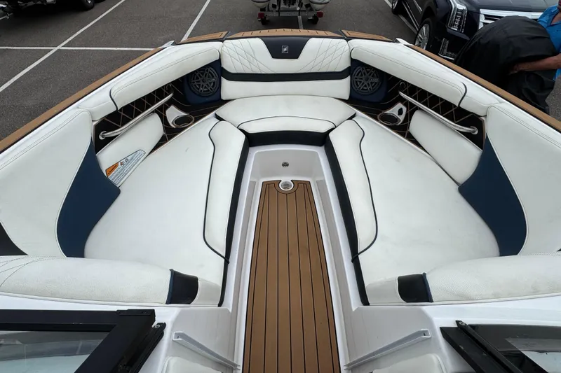 Slide: The Image of 2020 Nautique Super Air Nautique GS22 cockpit with steering wheel and luxurious seating. - 17