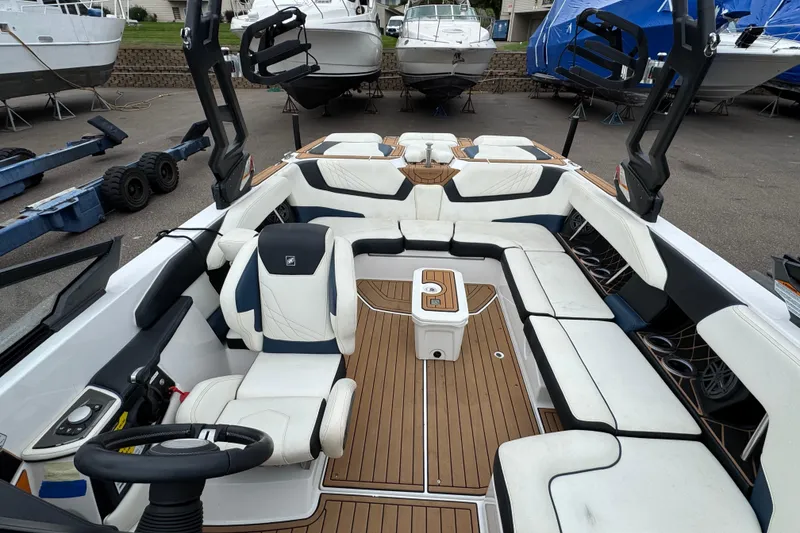Slide: The Image of 2020 Nautique Super Air Nautique GS22 cockpit with white seating and modern controls. - 18
