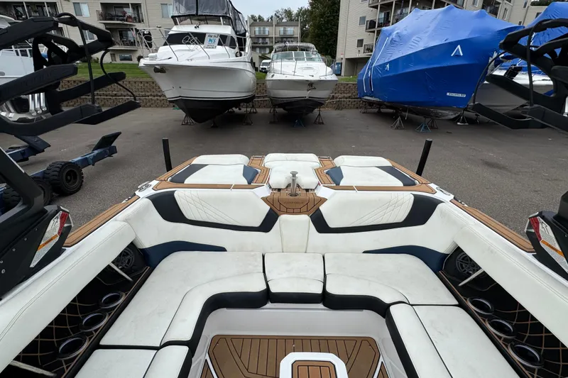 Slide: The Image of 2020 Nautique Super Air Nautique GS22 boat interior with white seating and wood accents. - 21
