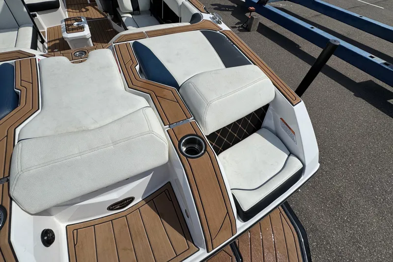 Slide: The Image of 2020 Nautique Super Air Nautique GS22 boat interior with white and black seating. - 22