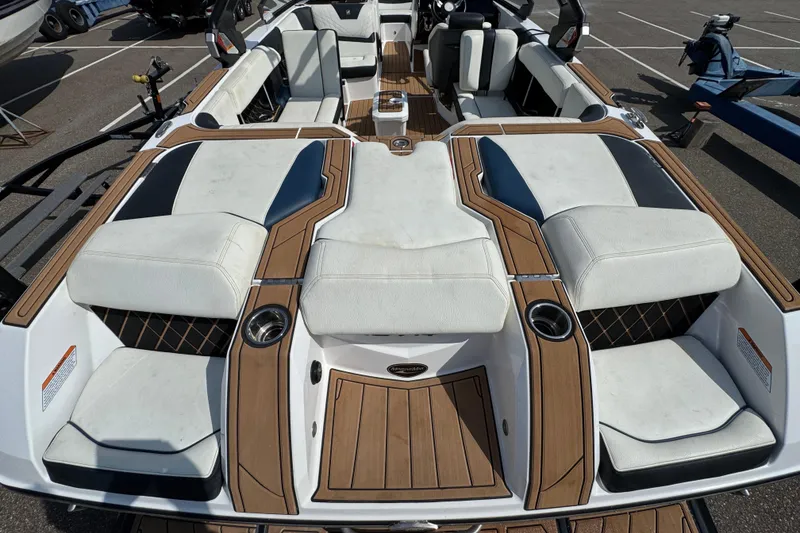 Slide: The Image of 2020 Nautique Super Air Nautique GS22 interior seating with white and black upholstery. - 23