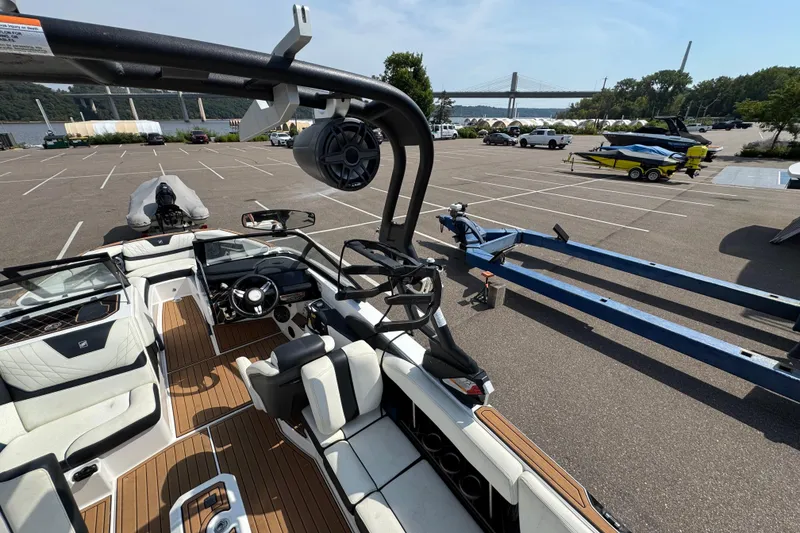 Slide: The Image of 2020 Nautique Super Air Nautique GS22 interior with white seating and teak flooring. - 28