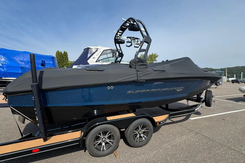 Slide: The Image of 2020 Nautique Super Air Nautique GS22 boat on trailer, covered and parked outdoors. - 3